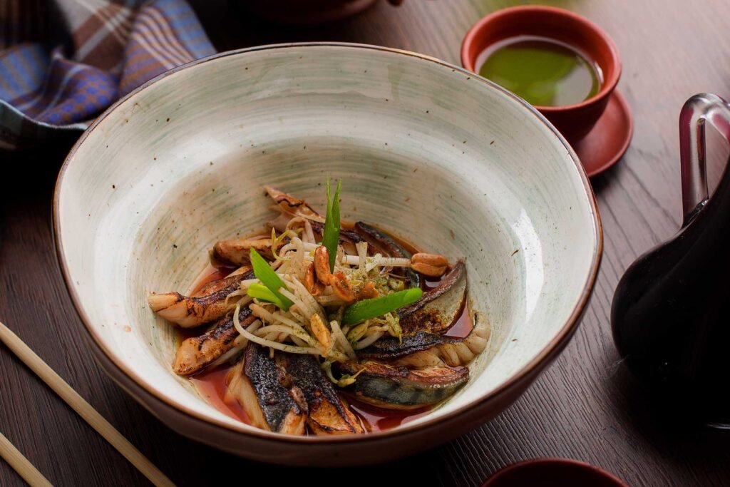 asian food fish with sprouts and peanuts in a res W4RE2DD